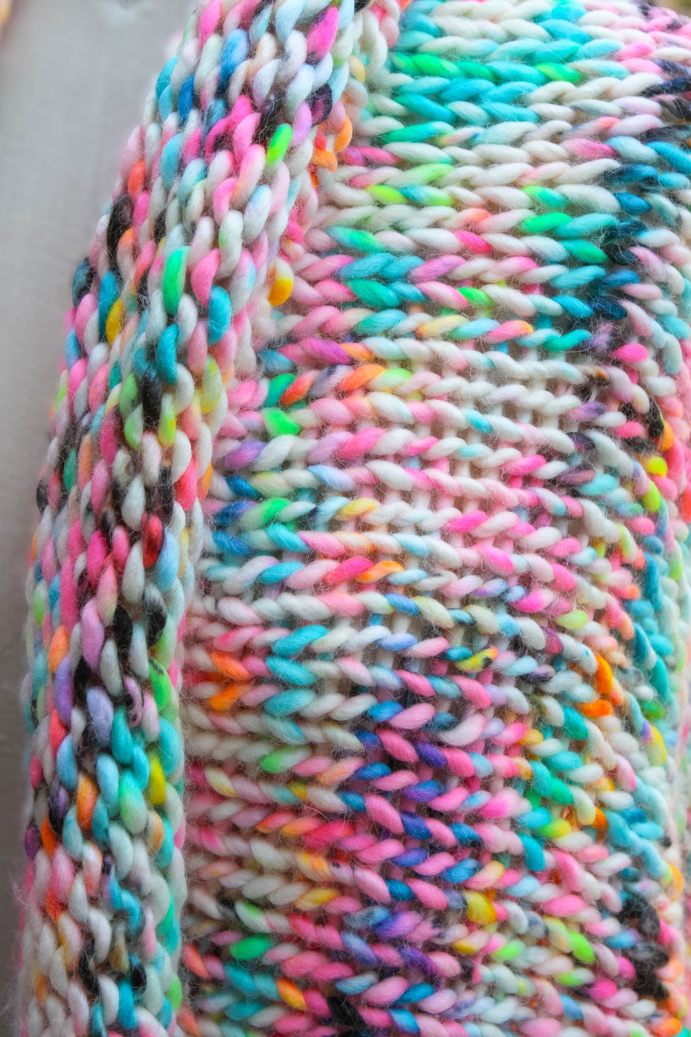 Close-up of luxury hand-knit shawl neckline, fine detail, color, and artisan texture luxury shawl, close up, fashion detail, handmade, wearable art