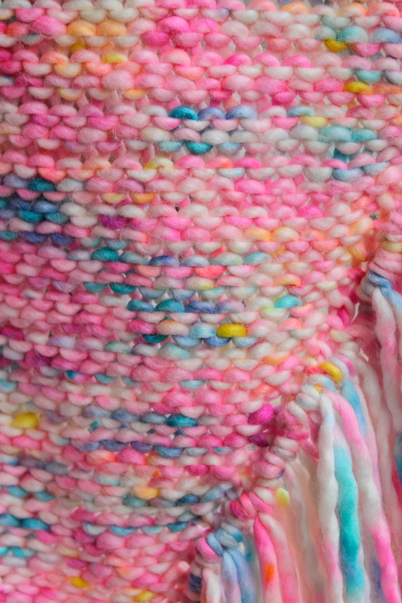 Macro view of knitwork — warm sunset palette, luxury handmade texture.