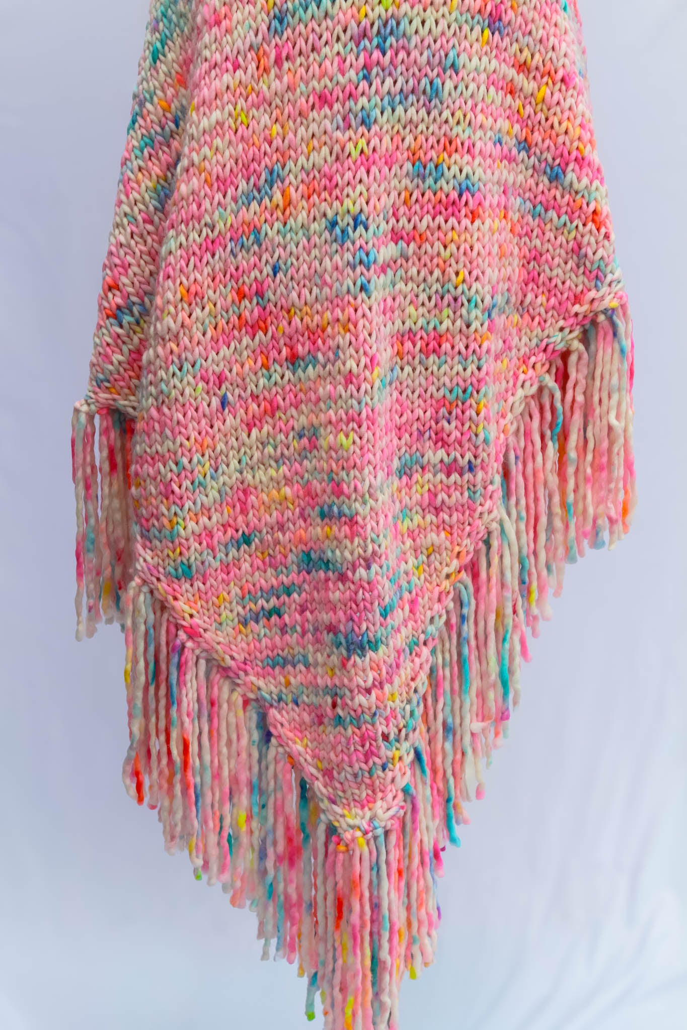 Hand-dyed, hand-knit shawl displayed on dress form — fine texture and color detail.