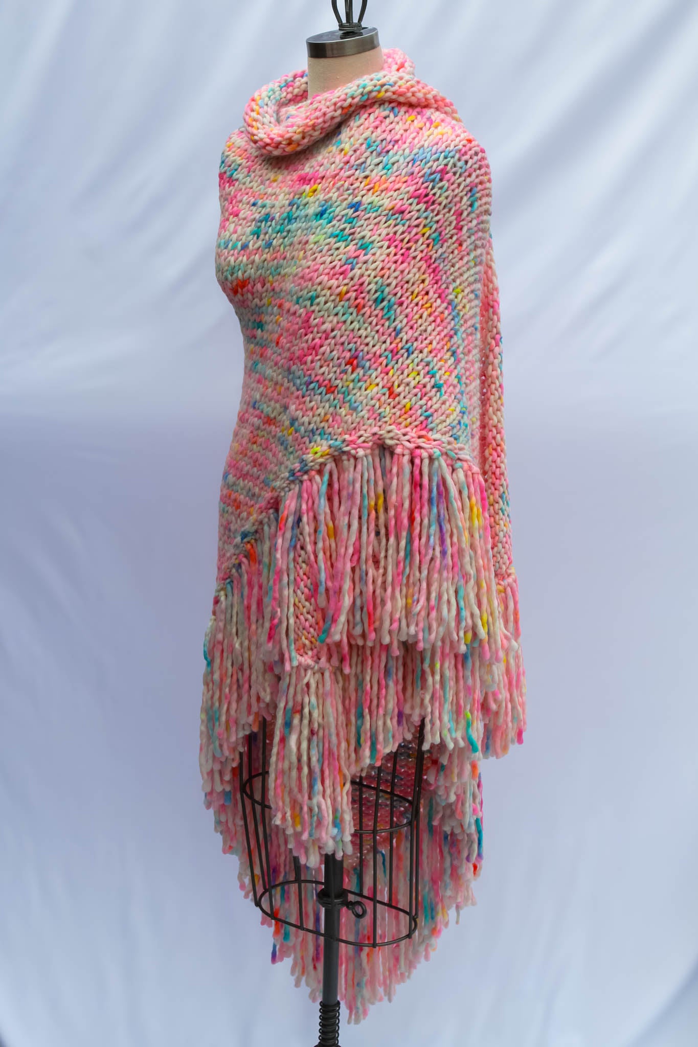 Luxury hand-knit shawl styled on dress form  wrapped side view showing artful drape and texture. luxury shawl, fashion styling, wearable art, handmade couture, Rasa Milo