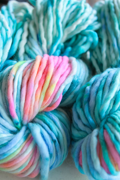 hand dyed yarn teal blues hint of neon pink and neon orange